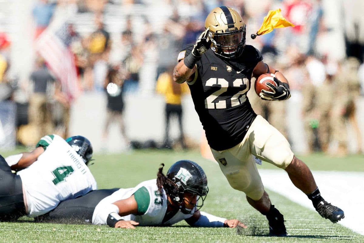 Calen Holt #22 of the Army Black Knights runs the ball as a flag is thrown during a game against the Hawaii Warriors at Michie Stadium in West Point, N.Y. on Sept. 15, 2018. Army defeated Hawaii 28-21.