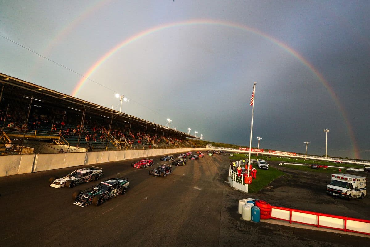A rainbow forms over turn four prior to the start of the Toyota Bud Mod Classic 150 for the NASCAR Whelen Modified Tour at At Oswego Speedway in Oswego, New York on September 3, 2022. (Bryan Bennett/NASCAR)