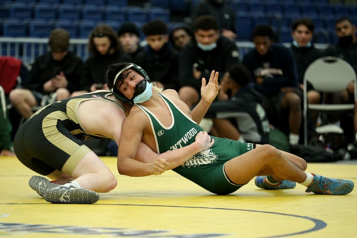 Brentwoods Brandon Reinoso, right, attempts to escape Wantaghs Jesse Vanorden during their 145 pound bout at the 2022 NYSPHSAA Wrestling Dual Meet Championships at SRC Arena in Syracuse, N.Y. on Jan. 29, 2022.