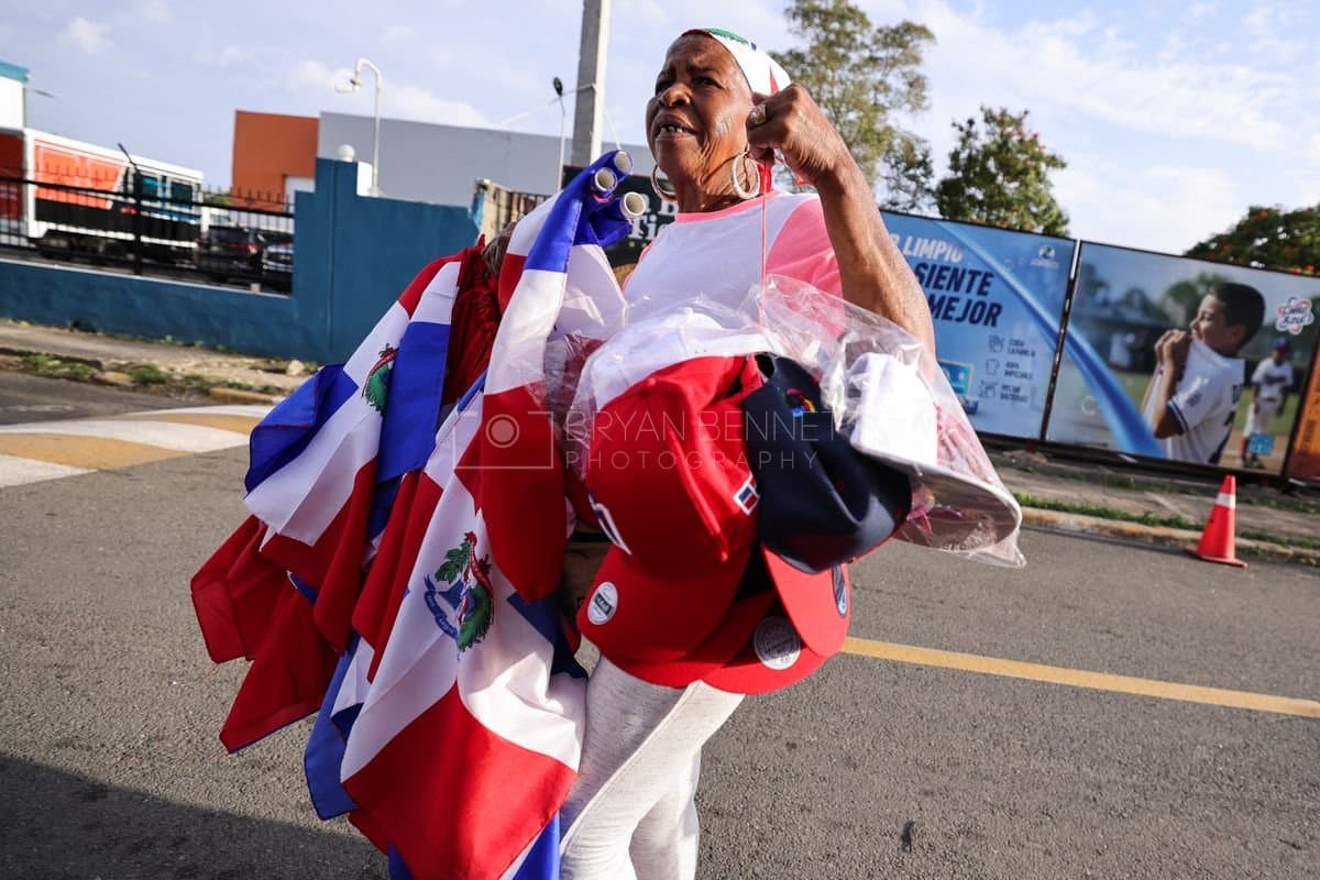 SANTO DOMINGO, DOMINICAN REPUBLIC - MARCH 03: A women is shown selling flags and hats prior to an exhibition game between the Detroit Tigers and the Dominican Republic at Estadio Quisqueya on March 03, 2026 in Santo Domingo, Dominican Republic. (Photo by Bryan Bennett/Getty Images)