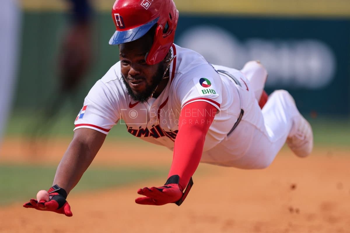 SANTO DOMINGO, DOMINICAN REPUBLIC - MARCH 04: Vladimir Guerrero Jr. #27 of the Dominican Republic slides into first base during an exhibition game against the Detroit Tigers at Estadio Quisqueya on March 04, 2026 in Santo Domingo, Dominican Republic. (Photo by Bryan Bennett/Getty Images)